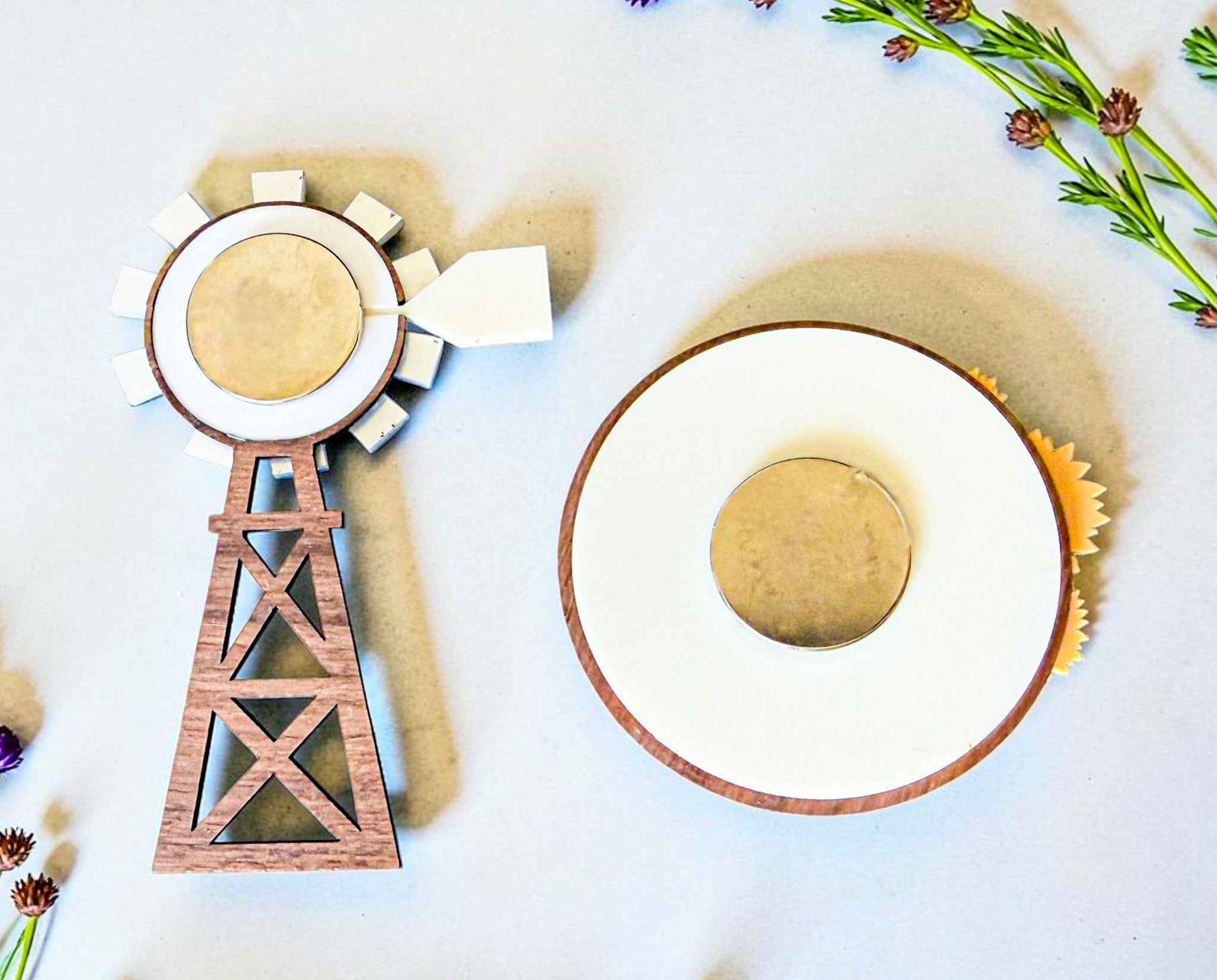 Back of farmhouse-style windmill and wagon wheel magnets from Farmhouse Whimsy magnet set, featuring rustic metal designs.
