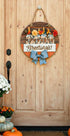 Farmhouse Whimsy Fall Greetings door sign hanging on porch with autumn-themed design and warm colors.