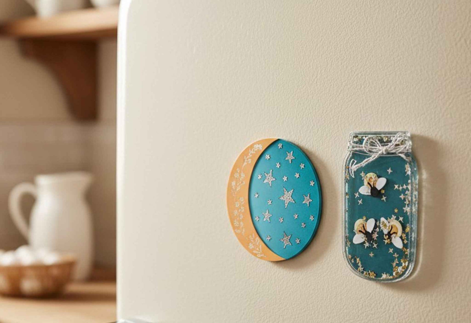 Firefly and moon magnet set by Farmhouse Whimsy displayed on a fridge, featuring colorful, whimsical designs for home decor.