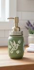 Green hummingbird mason jar soap dispenser by Farmhouse Whimsy with a rustic design and pump top for liquid soap.