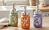 Hummingbird mason jar soap dispenser with a rustic farmhouse design, featuring a clear glass jar and a metal pump.