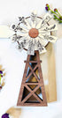 Farmhouse Whimsy windmill and wagon wheel magnet set showing vintage-inspired metal magnets with detailed designs.