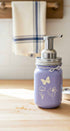 Farmhouse Whimsy butterfly mason jar soap dispenser with peach liquid soap and pump, decorative soap jar for kitchen or bathroom.