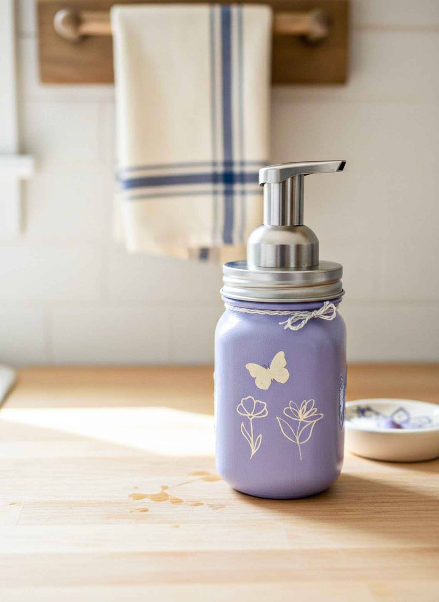Farmhouse Whimsy butterfly mason jar soap dispenser with peach liquid soap and pump, decorative soap jar for kitchen or bathroom.