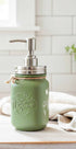 Farmhouse Whimsy butterfly mason jar soap dispenser with peach-colored liquid soap and pump, decorative farmhouse-style soap jar