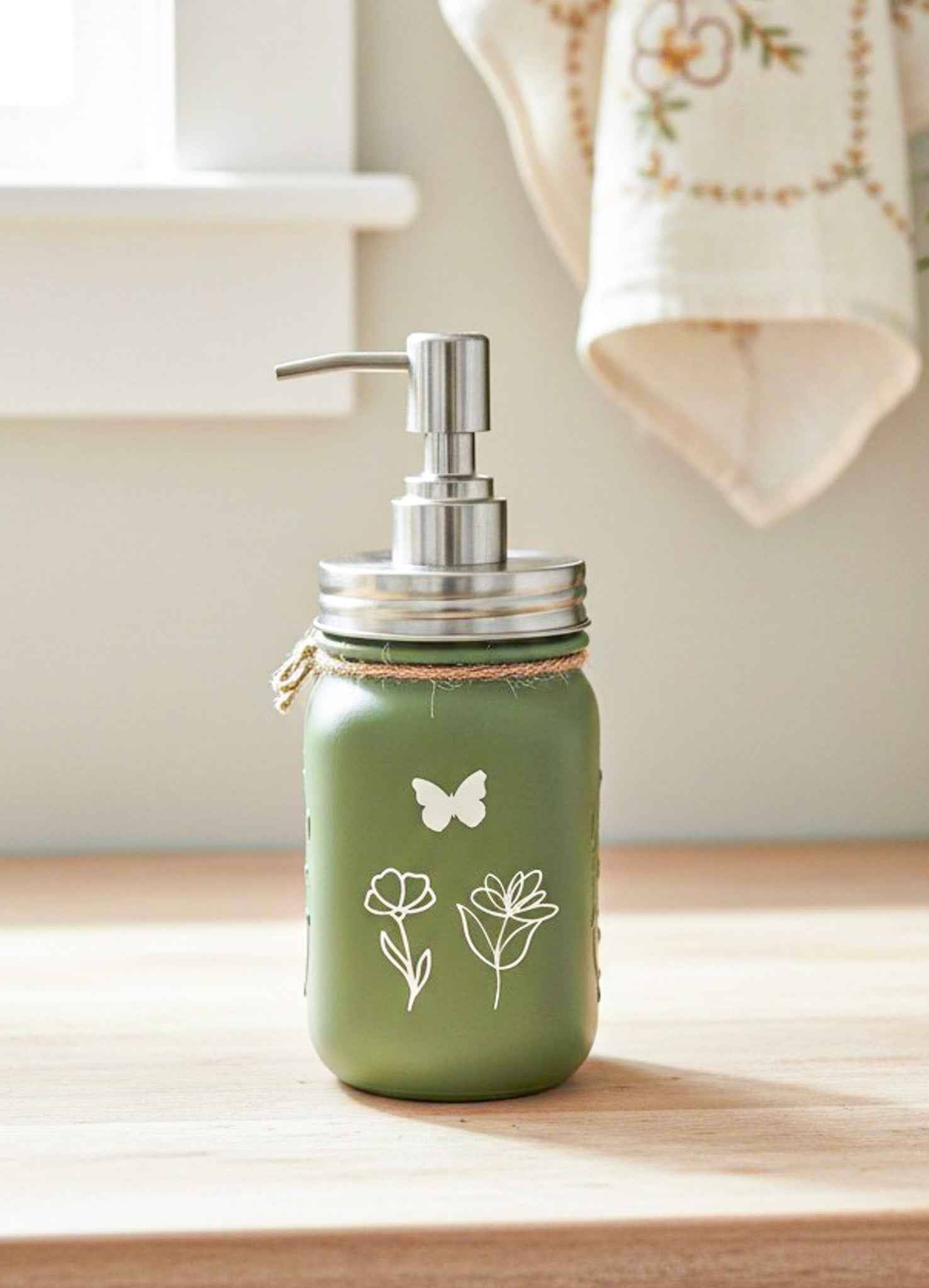 Farmhouse Whimsy butterfly mason jar soap dispenser with peach liquid soap and pump, decorative soap jar for kitchen or bathroom.