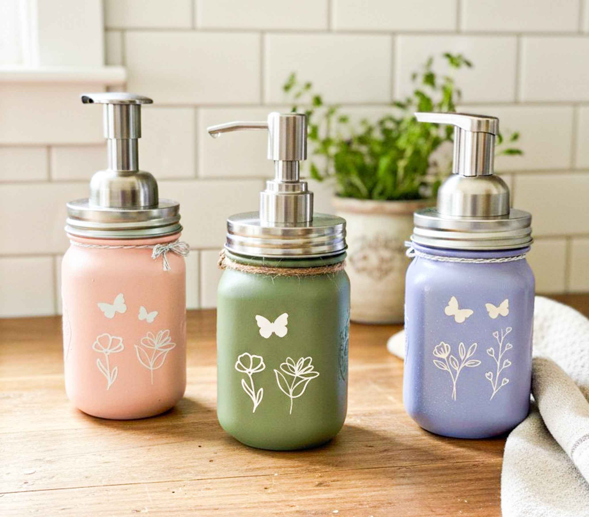 Farmhouse Whimsy butterfly mason jar soap dispenser with peach liquid soap and a pump, decorative farmhouse style soap jar