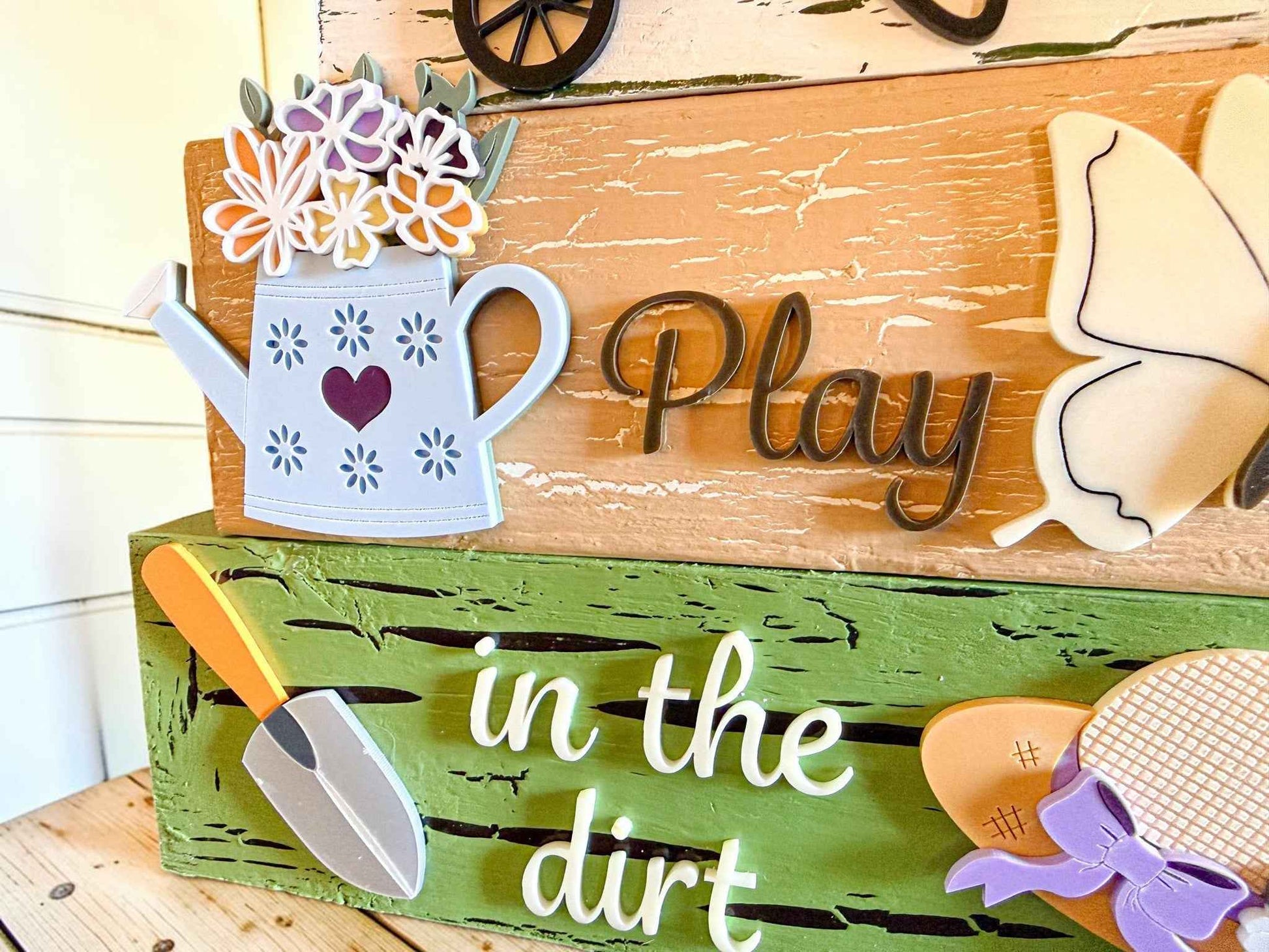 Farmhouse Whimsy gardening table top decor with tiered block set, featuring rustic farmhouse design and decorative gardening theme.