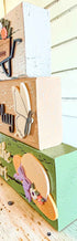 Farmhouse Whimsy gardening table top decor with tier block set, featuring rustic, decorative garden-themed wooden blocks.