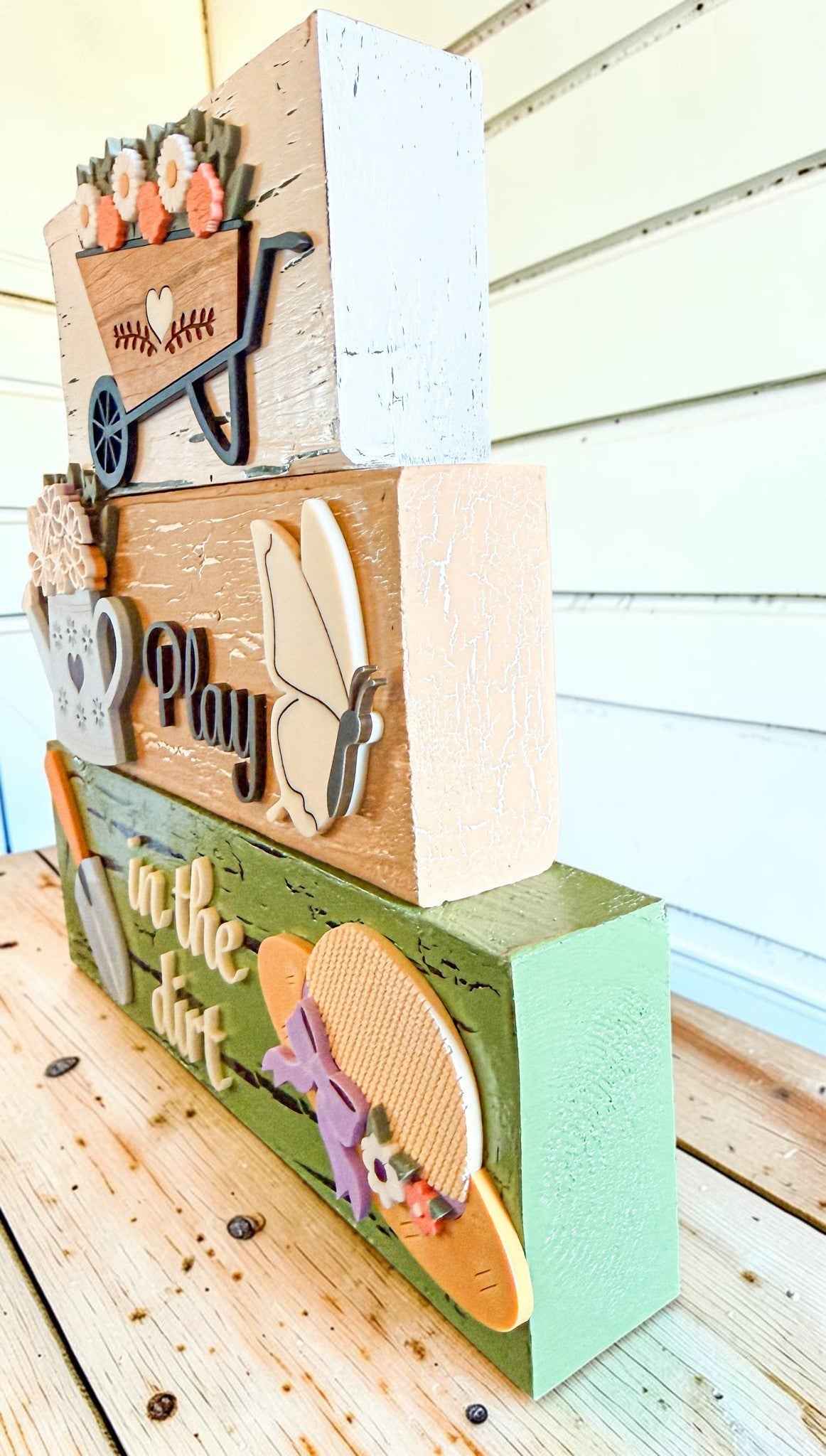 Farmhouse Whimsy gardening table top decor with tier block set, featuring rustic, decorative garden-themed wooden blocks.
