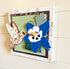 Hummingbird and columbine flower wall art by Farmhouse Whimsy showcasing colorful nature scene with vibrant blooms and bird.