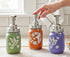 Farmhouse Whimsy hummingbird mason jar soap dispenser with hand-painted design, featuring a decorative hummingbird motif.