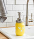Farmhouse Whimsy sunflower mason jar soap dispenser on a countertop, rustic style soap jar with sunflower design.