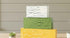 Sunflower-themed table top decor with tiered block set from Farmhouse Whimsy, featuring wooden blocks with sunflower designs.